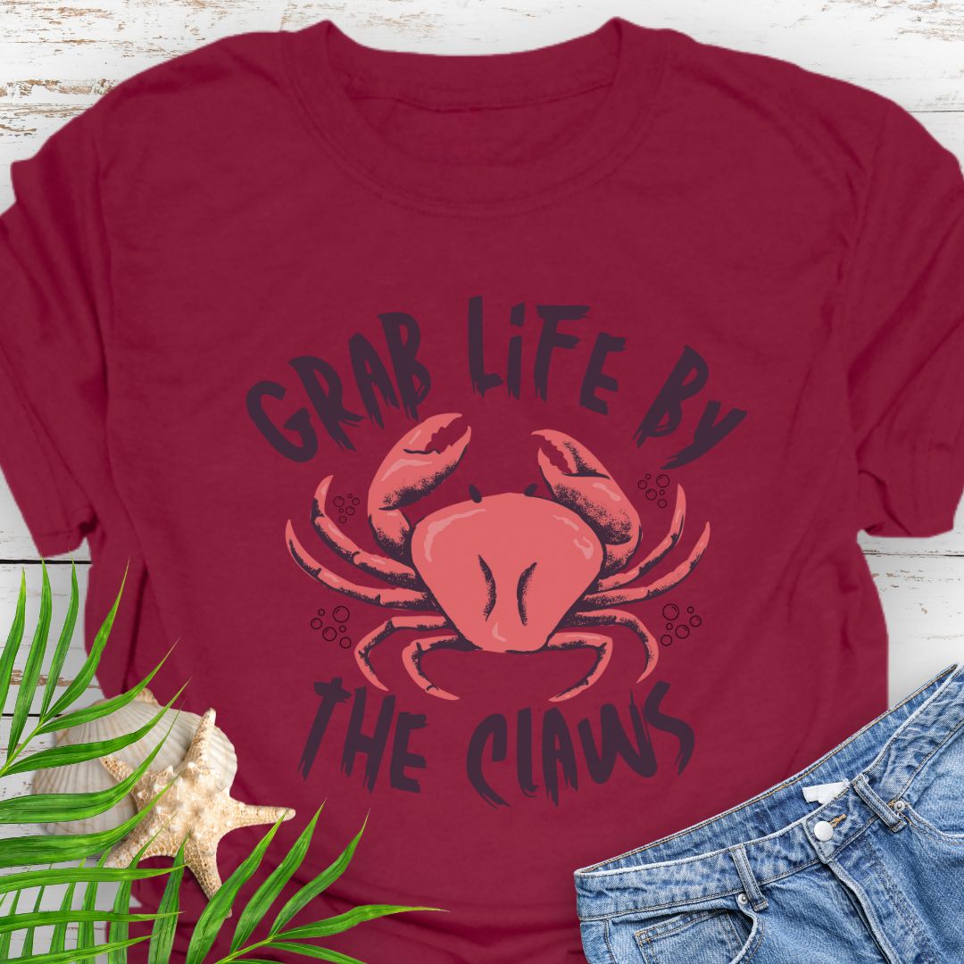 Cardinal Red Unisex t-shirt with 'Grab Life by the Claws' crab graphic on front – coastal-themed summer apparel