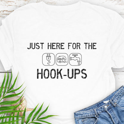White  funny camping t-shirt with ‘Here for the Hook-ups’ text and RV utility icons.