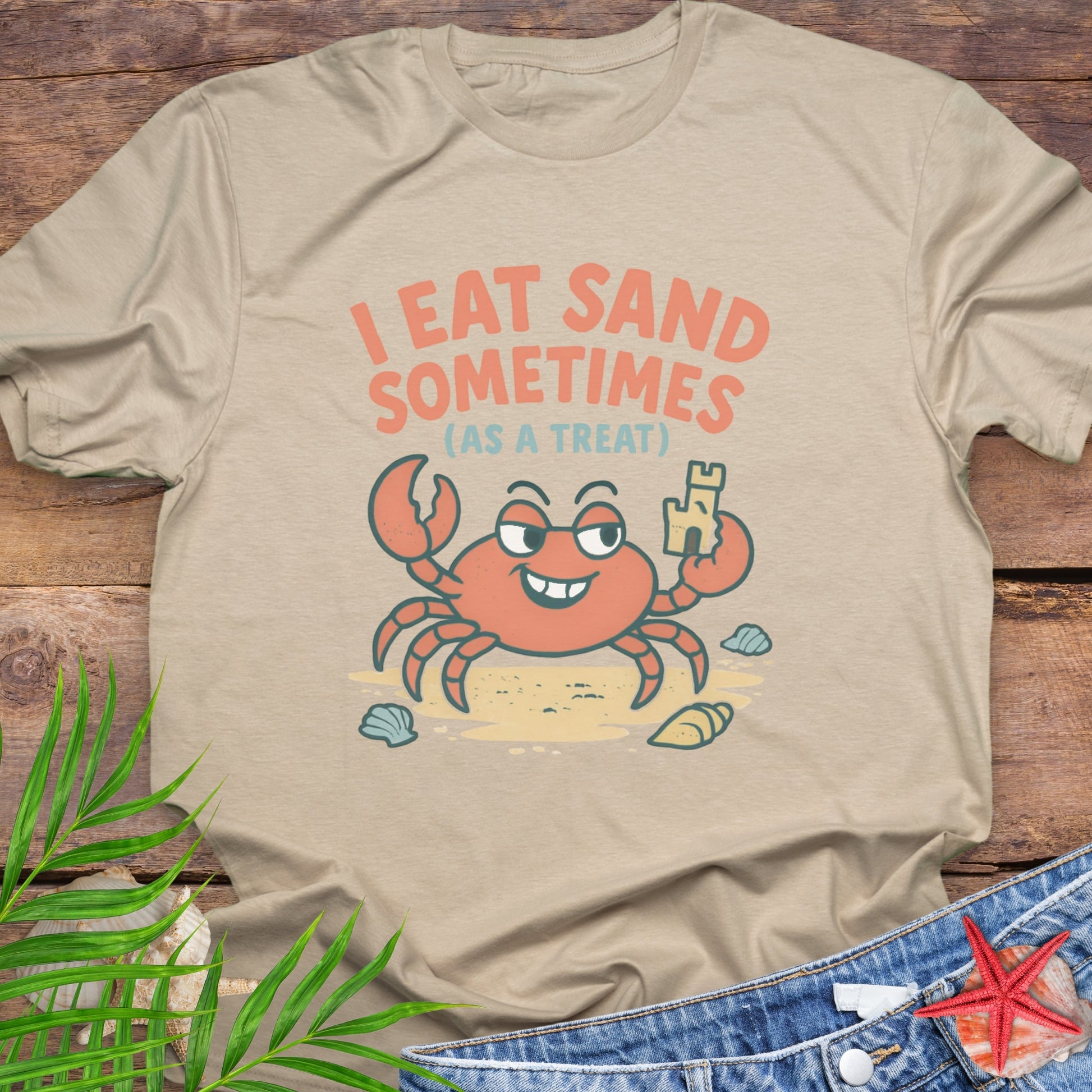 Beige I Eat Sand Sometimes as a Treat shirt featuring crab holding sandcastle.
