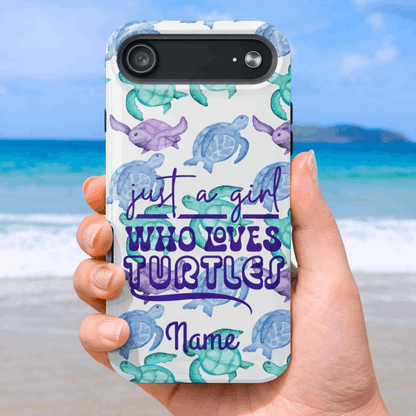 iPhone 17 air Phone case with turtle design and text 'just a girl who loves turtles' held by a hand on a beach.