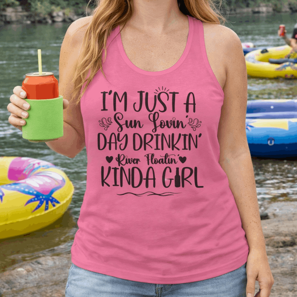 Woman wearing a pink tank top with text  "Sun-loving, Day-drinking, River-floating Kind of Girl". 