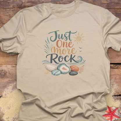 A beige "Just One More Rock" graphic  unisex t-shirt featuring colorful beach stones and agates.