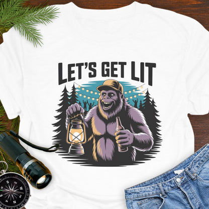 White "Let's Get Lit" Sasquatch T-Shirt  featuring a sasquatch wearing a baseball hat holding a camping lantern and a beer in a party scene in the woods.