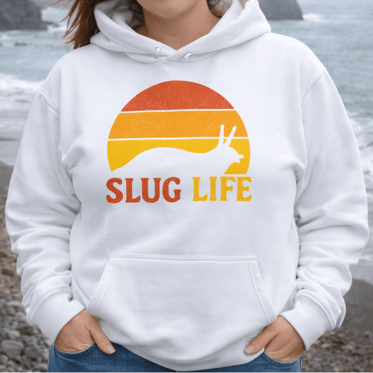 Woman wearing a white hoodie with 'SLUG LIFE' retro sunset design.