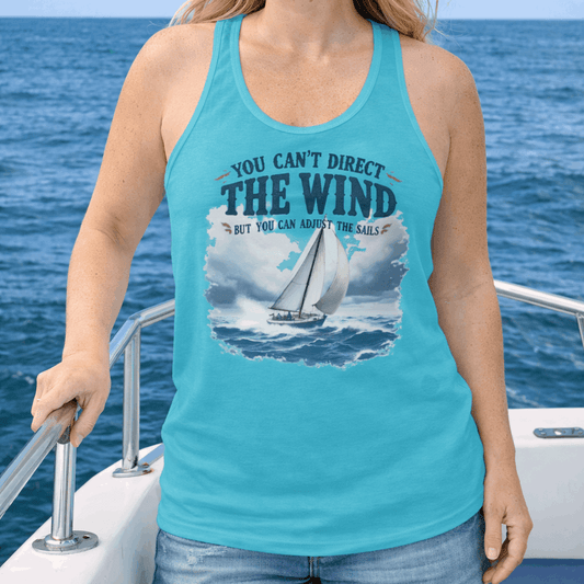 Woman on a boat wearing a turquoise tank top with a sailboat graphic and text You Can't Direct the Wind But You Can  Adjust the Sails.
