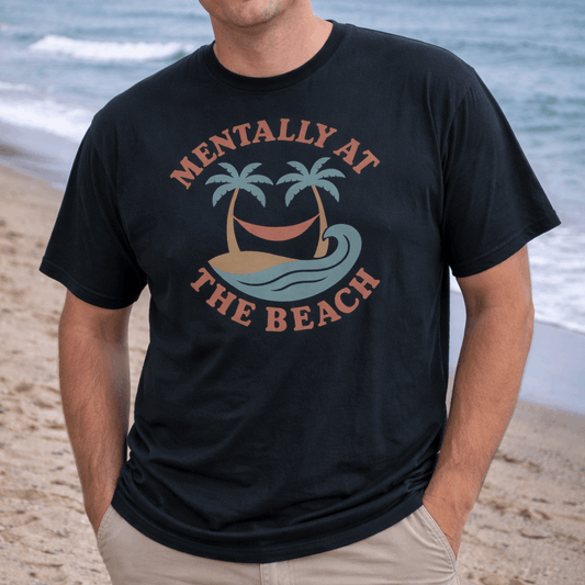 Man wearing a black t-shirt with 'Mentally at the Beach' text with retro design of palm trees with a hammock, and gentle ocean waves.