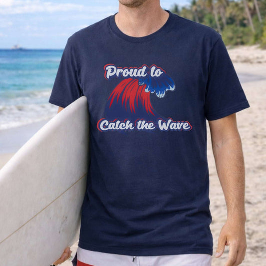 Person wearing a navy blue  t-shirt with red and blue wave with red, blue and white text Proud to Catch the Wave.