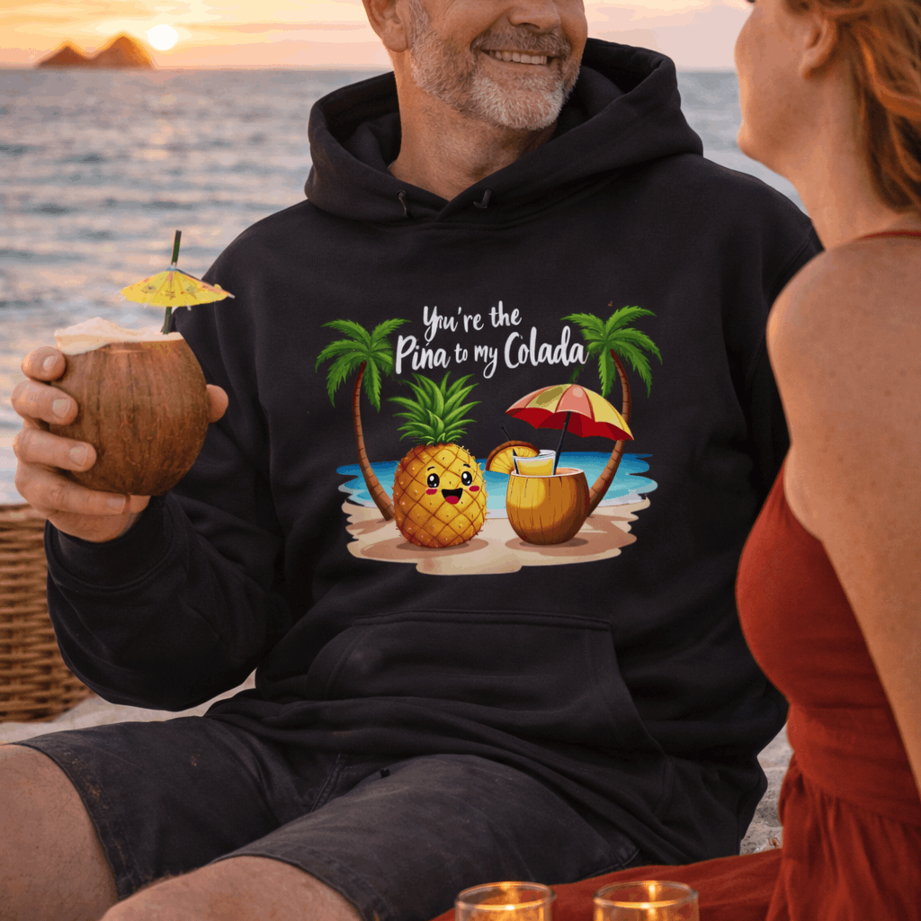 Man wearing a hoodie with a pineapple graphic and text You're the Pina to My Colada.