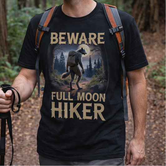 Man wearing a black t-shirt with 'Beware Full Moon Hiker' design in a forest setting