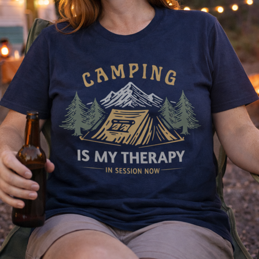 Person wearing a 'Camping is my Therapy' shirt at a campsite.