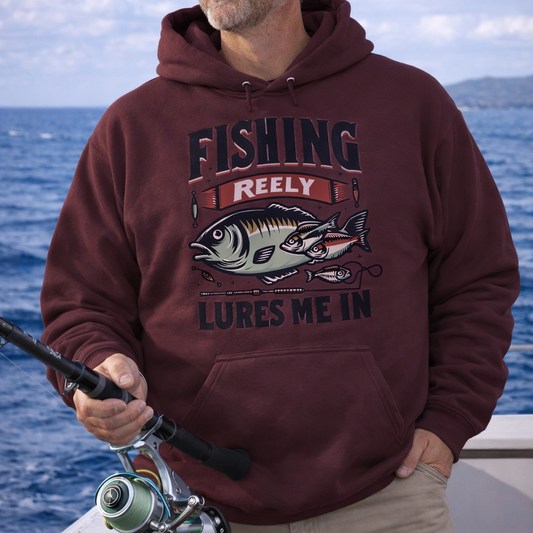 Man wearing a hoodie with a fishing graphic and text Fishing Reely Lures Me In.