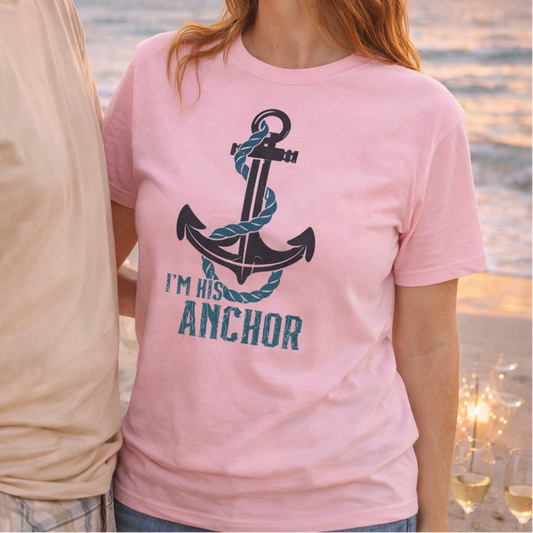 Woman wearing a pink t-shirt with an anchor design and 'I'm his anchor' text on a beach at sunset.