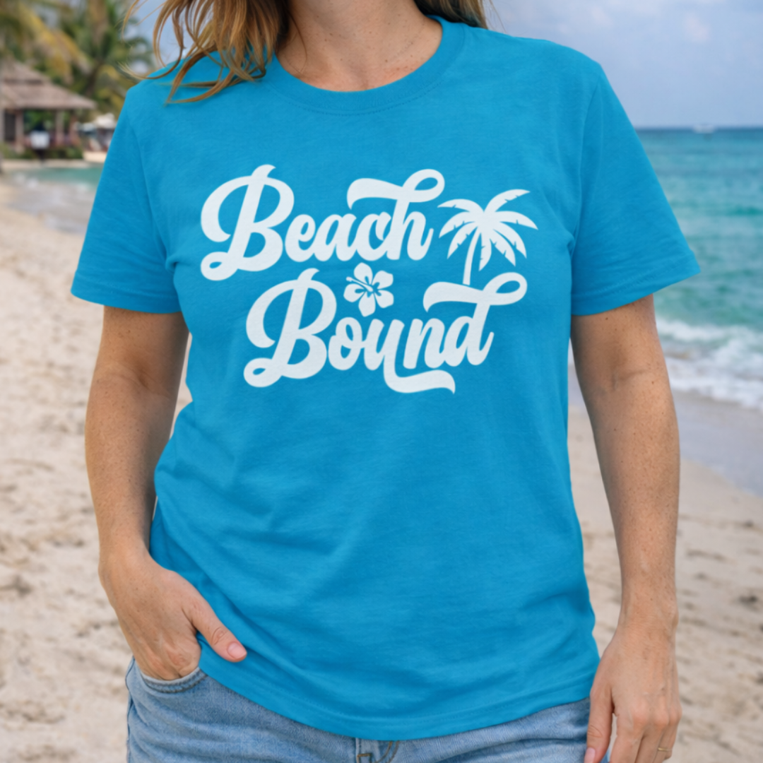 Person wearing a blue 'Beach Bound' t-shirt on a beach