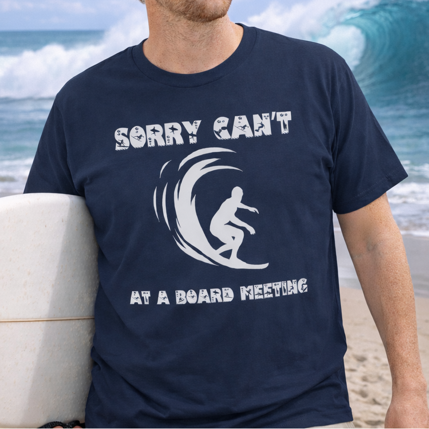 Man wearing a navy blue t-shirt with a surfing graphic and humorous text Sorry Can't at a Board Meeting.