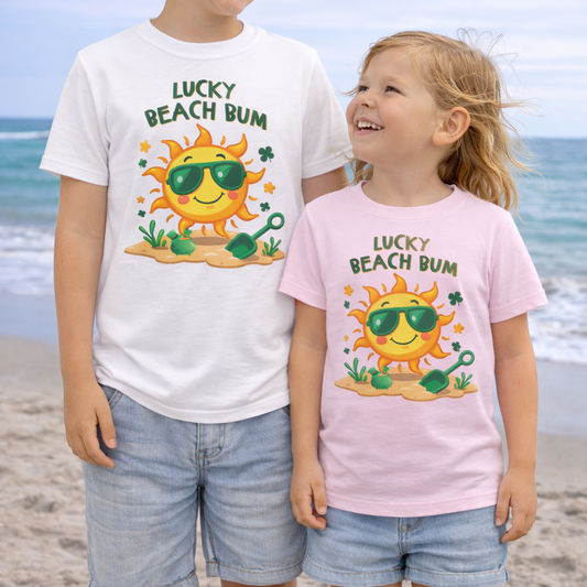 Two children wearing 'Lucky Beach Bum' St Patrick's Day t-shirts on a beach.