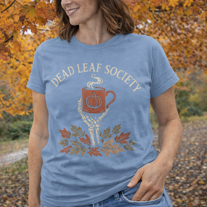 Person wearing a blue t-shirt with 'Dead Leaf Society' design in an autumn setting