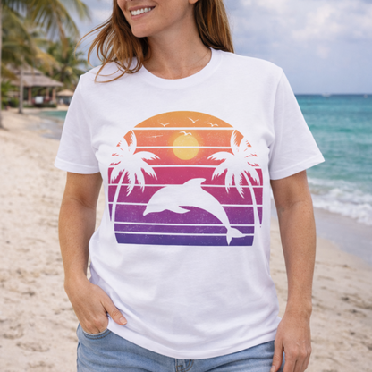 Person wearing a white t-shirt with a colorful retro rainbow dolphin and palm tree design.