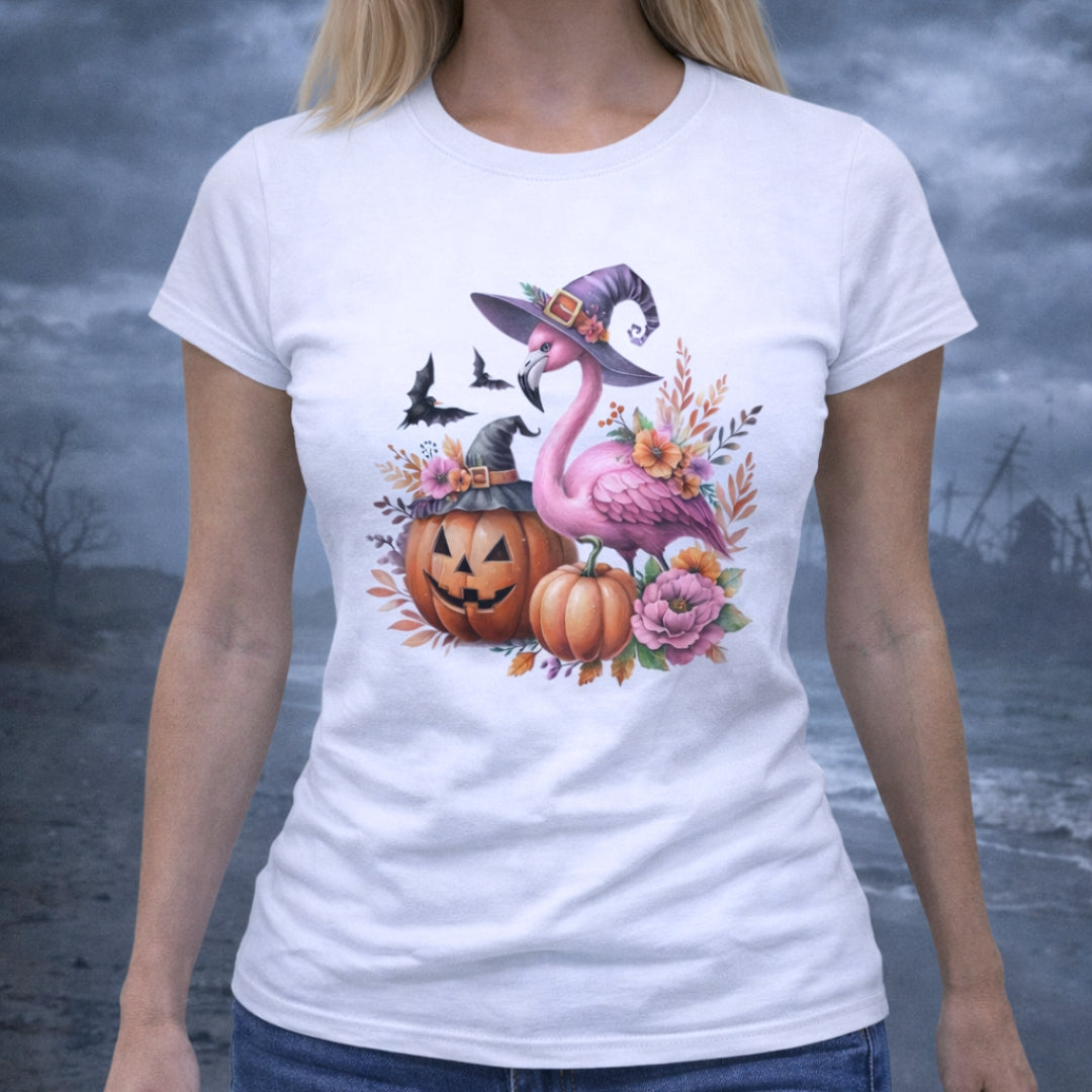White t-shirt with Halloween-themed design featuring a flamingo wearing a witches hat, pumpkins, and flowers.