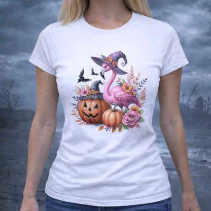 White t-shirt with Halloween-themed design featuring a flamingo wearing a witches hat, pumpkins, and flowers.