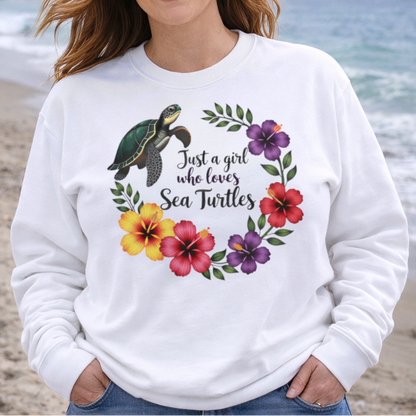 A white sweatshirt with hibiscus flowers and a sea turtle with text Just a Girl Who loves Sea Turtles.