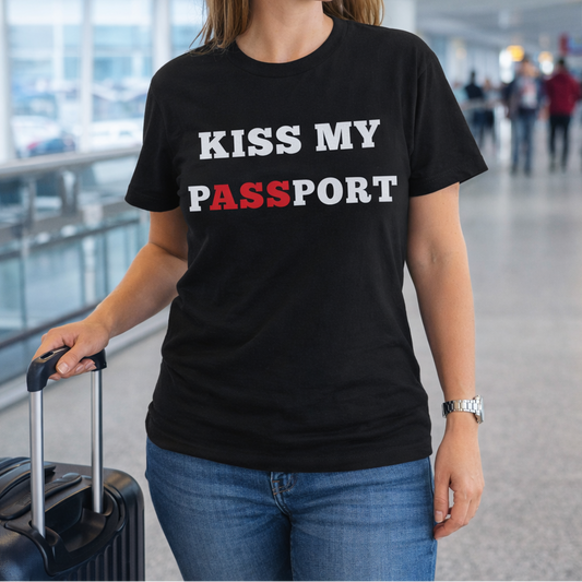 Person wearing a black t-shirt with 'KISS MY PASSPORT' text in an airport.