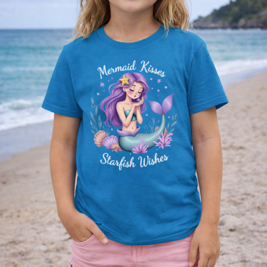 Child wearing a blue t-shirt with a mermaid graphic with text Mermaid Kisses Starfish Wishes.