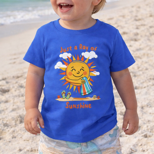 Child wearing a blue t-shirt with a sun graphic and text Just a Ray of Sunshine.