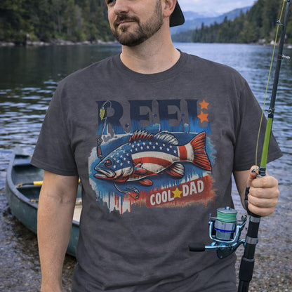 Grey unisex t-shirt with a patriotic bass fish graphic and text REEL Cool Dad – fishing themed Father's Day shirt.