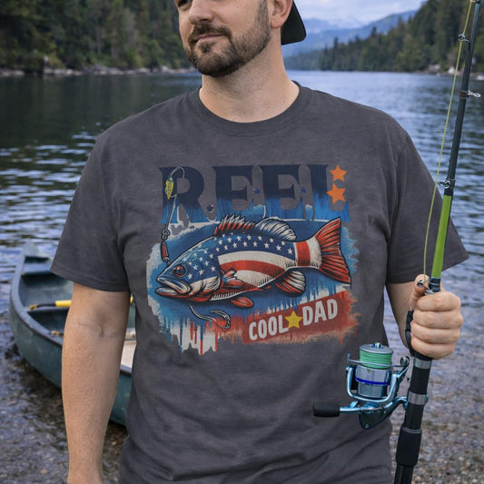 Grey unisex t-shirt with a patriotic bass fish graphic and text REEL Cool Dad – fishing themed Father's Day shirt.