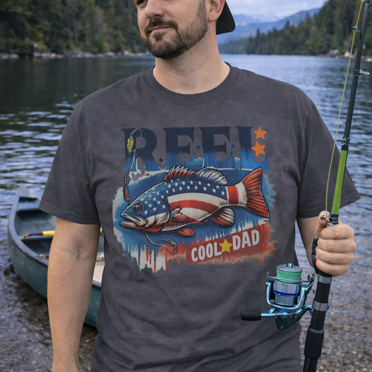 Grey unisex t-shirt with a patriotic bass fish graphic and text REEL Cool Dad – fishing themed Father's Day shirt.