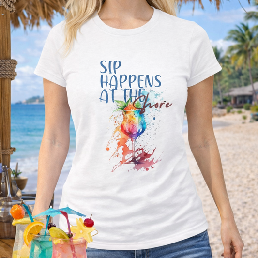 Person wearing a white t-shirt with a colorful cocktail graphic and text Sips Happen at the Shore. 