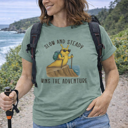 Person hiking with a t-shirt featuring a cartoon slug hiking at the coast.