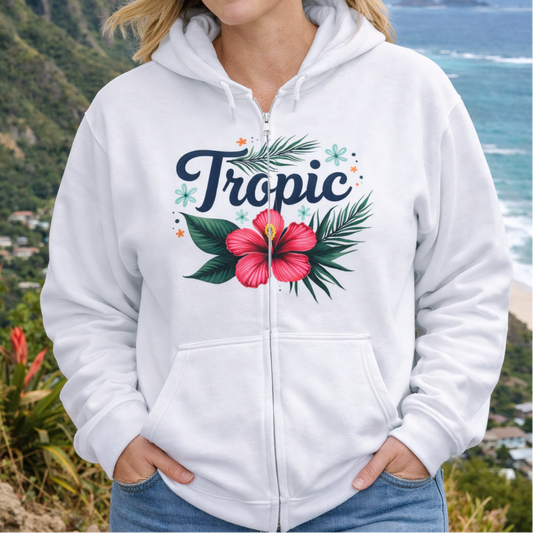 Woman wearing a white hoodie with tropical design and hibiscus flower.
