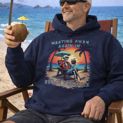 A navy blue hoodie with a skeleton in a Hawaiian Shirt sitting under a beach umbrella on the beach at sunset with a coconut drink between two palm trees that says Wasting Away in Beach Paradise. 