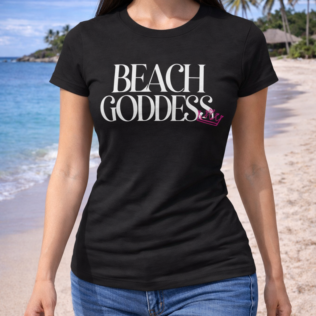 Woman wearing a black t-shirt with 'Beach Goddess' text on a beach.