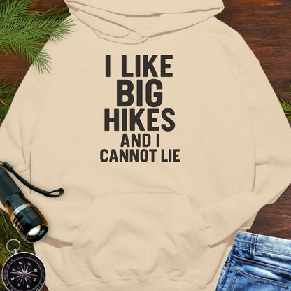 Beige hoodie with 'I LIKE BIG HIKES AND I CANNOT LIE' text, surrounded by hiking gear on a wooden surface.