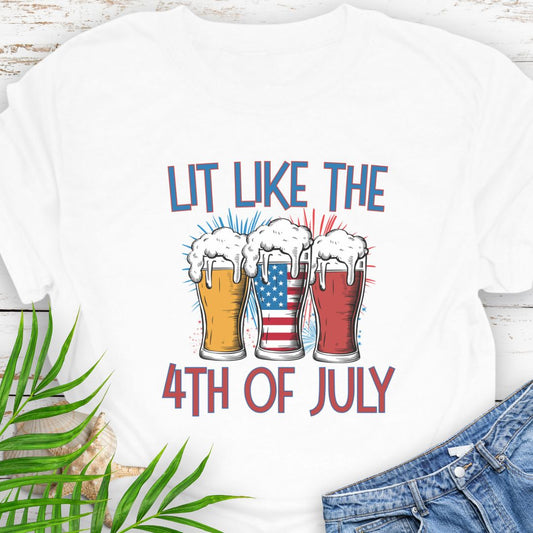 White T-shirt graphic showing three pint glasses of beer with one filled by the American flag and the phrase "Lit Like the 4th of July" in bold lettering.