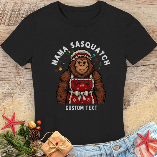 Black t-shirt with a graphic of a woman sasquatch wearing a Santa hat with custom text.
