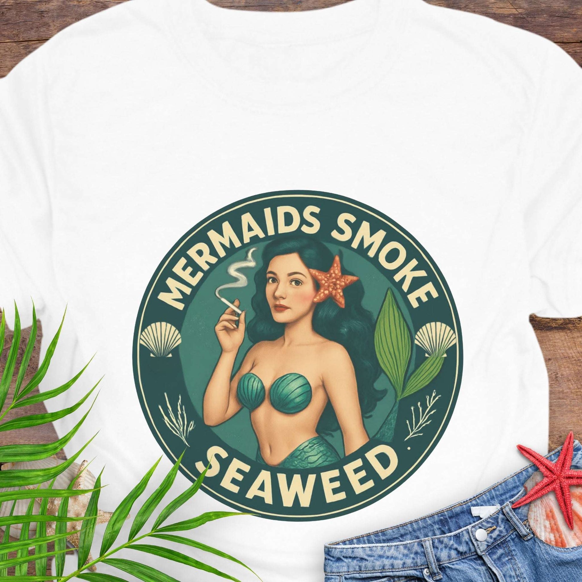 White t-shirt with mermaid graphic and 'Mermaids Smoke Seaweed' text.