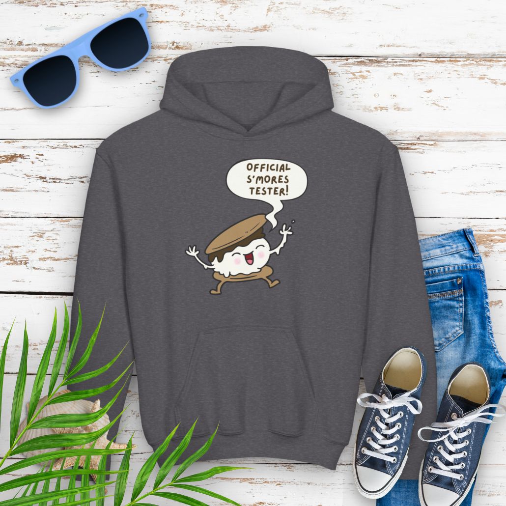 Dark Heather Gray Youth hoodie with "Official S’mores Tester" text in a speech bubble with cartoon s'more – fun camping-themed sweatshirt for kid.