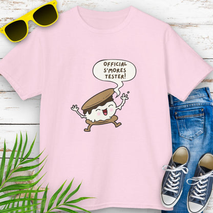 Pink child’s t-shirt with "Official S’mores Tester"  speech bubble and cartoon s'more– fun campfire-themed shirt for kids.
