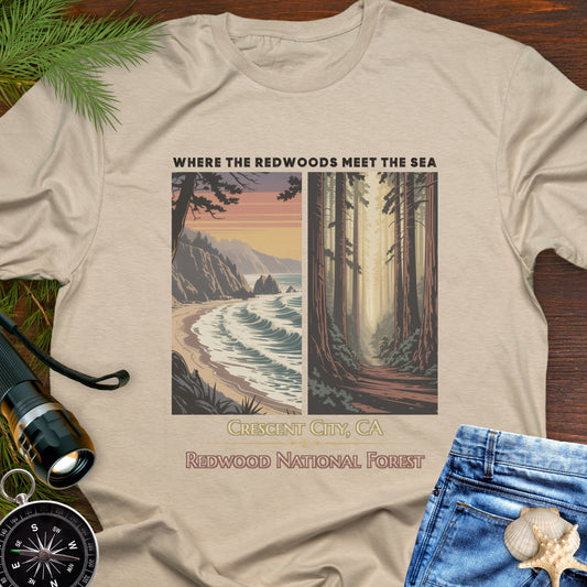 Beige t-shirt with Redwood National Forest design on a wooden surface with nature-themed accessories.