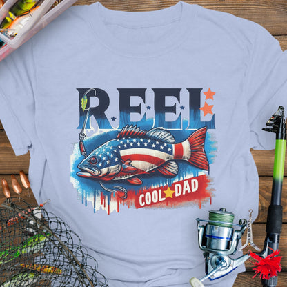 Light Blue patriotic fishing T-shirt with red, white, and blue design and the phrase “Reel Cool Dad”.
