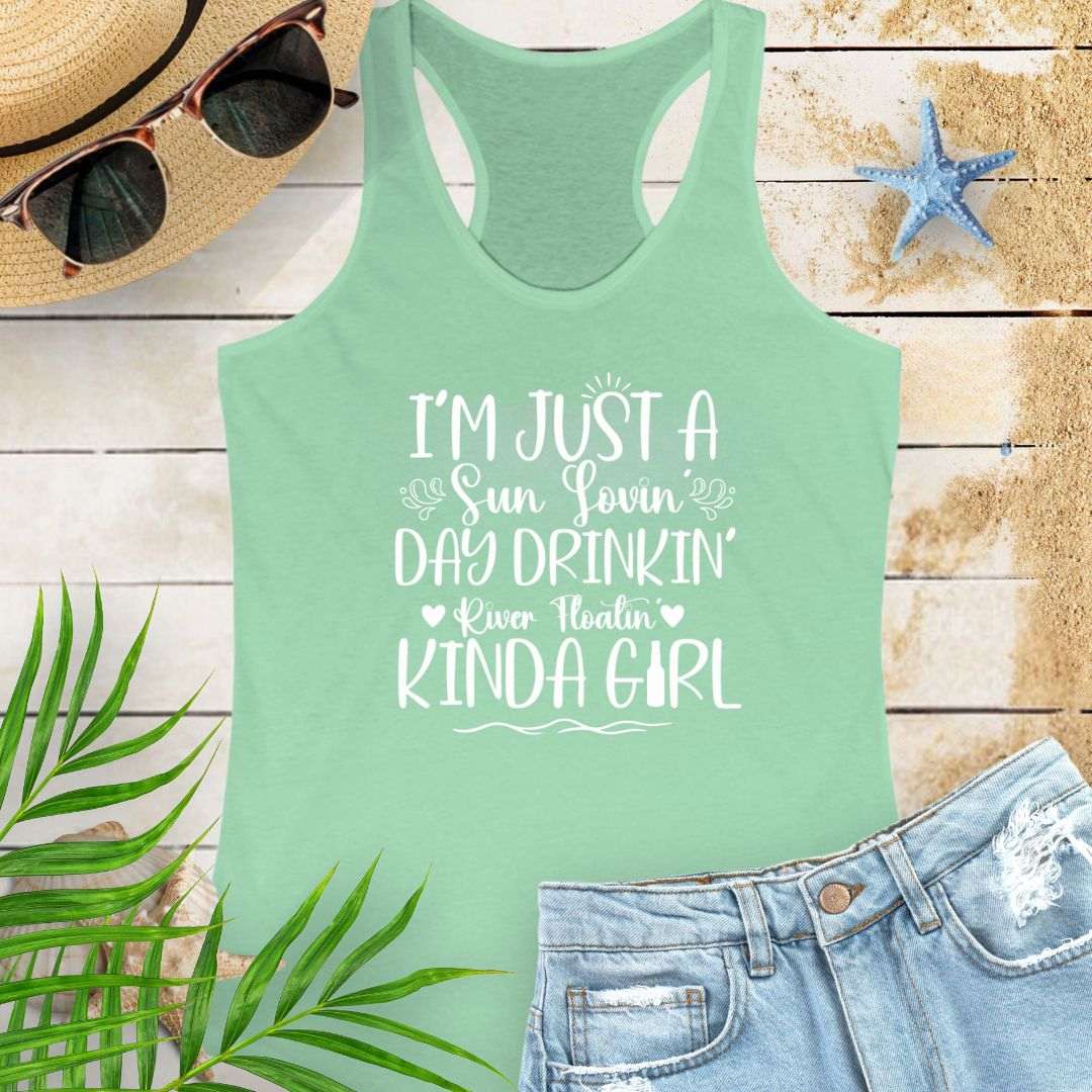 Mint Green women’s racerback tank top with the phrase "Sun-loving, Day-drinking, River-floating Kind of Girl" printed on the front in a relaxed, summer-ready fit.