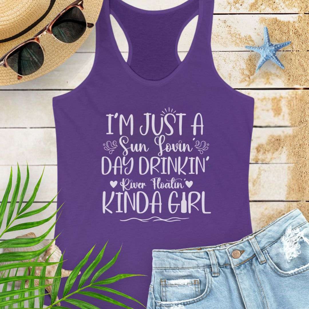 Purple women’s racerback tank top with the phrase "Sun-loving, Day-drinking, River-floating Kind of Girl" printed on the front in a relaxed, summer-ready fit.