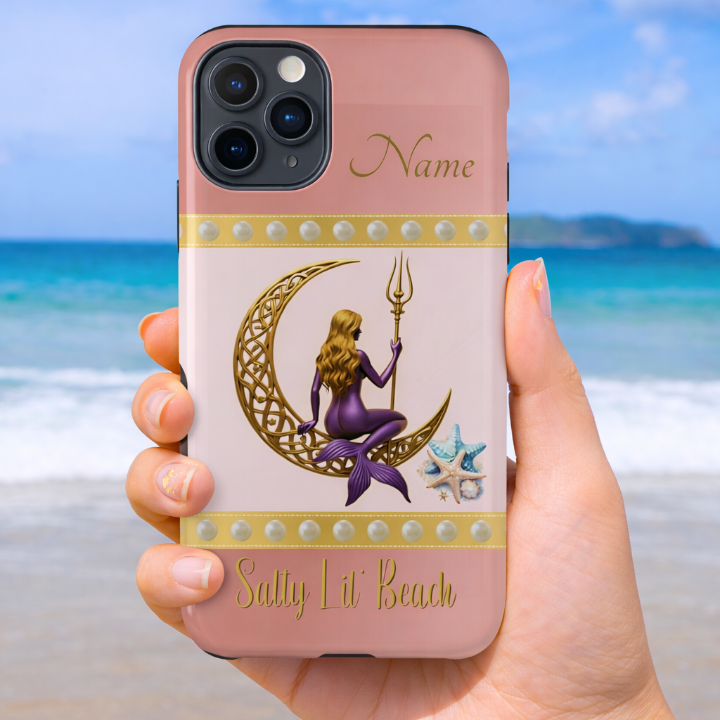 Phone case with mermaid sitting on a gold Celtic crescent moon and holding a trident with the text 'Salty Lil' Beach' on a pink and white background held by a hand on a beach background