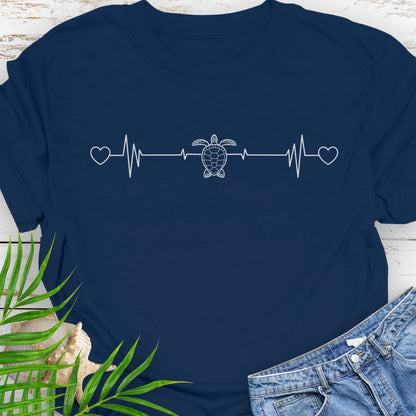 Navy T-shirt with ocean heartbeat design with sea turtle in center symbolizing love for sea turtles.