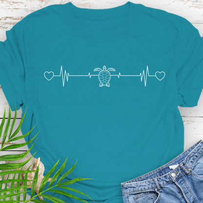 Tropical Blue T-shirt with ocean heartbeat design with sea turtle in center symbolizing love for sea turtles.