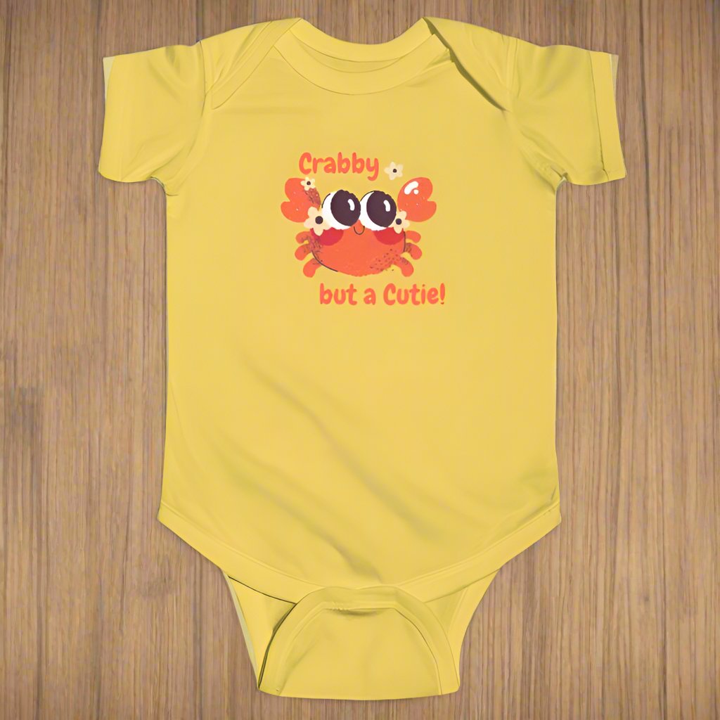 Yellow short sleeved body suit with cartoon crab that says crabby but a cutie