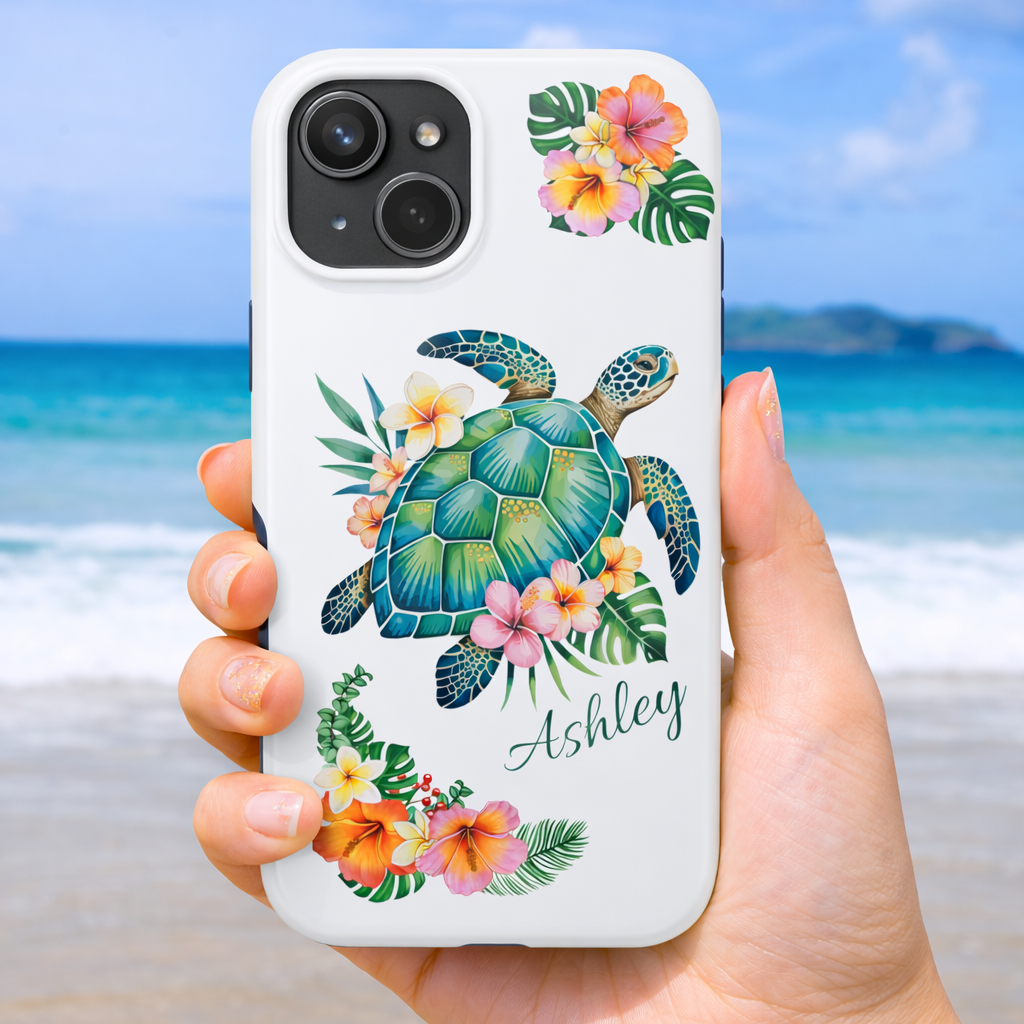 iPhone 17 phone case with a sea turtle design with hibiscus flowers and can be personalized held against a beach background.